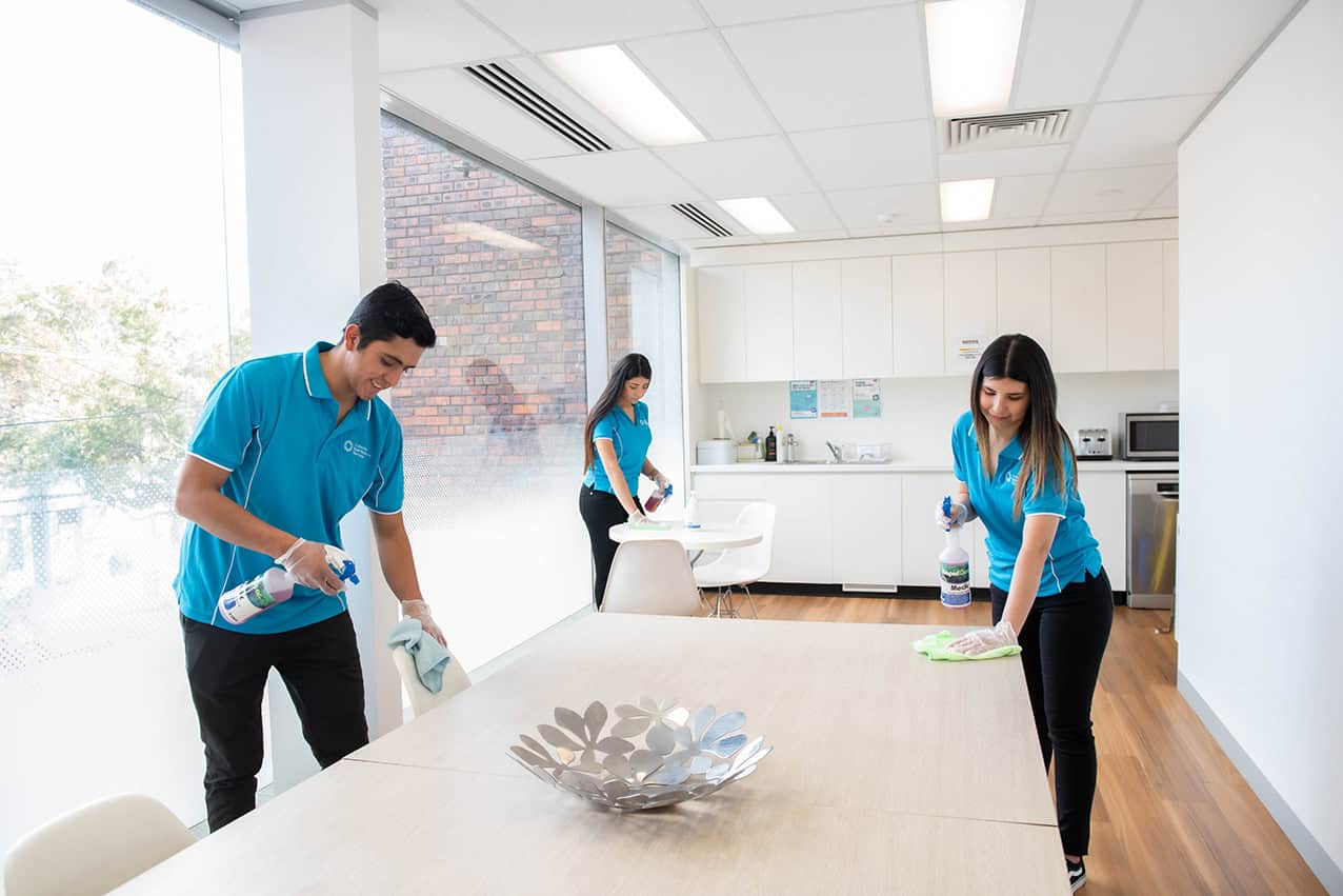 CMS team cleaning a modern office meeting room